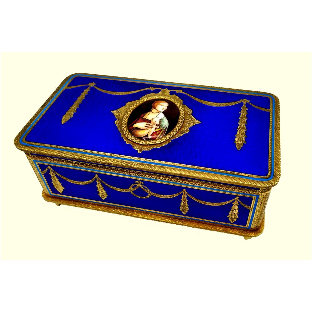 4313-4877- Large table box with mechanical musical movement with 3 different motifs by the firm Reuge S.A. Switzerland in 925/1000 sterling silver gold plated with translucent fire enamels on sunburst guillochè and fine hand-engraved decorations in the style of French Empire Napoleon III, on lid and sides. At center fine oval miniature cm. 4 x 5.3 fire-enameled reproducing Leonardo da Vinci's "Lady with ermine," hand-painted by painter Beatrice Mellana. Measures 10.7 x 19.7 cm. 7.8 cm. high. Weight gr. 1,590-. Designed by Franco Salimbeni in 1970 and produced in Florence in several examples and colors at the Salimbeni firm's headquarters with handwork by skilled artisan artists with thick plate and large reinforcements suitable for sustaining numerous enamelling firings at high fire at about 800° C.