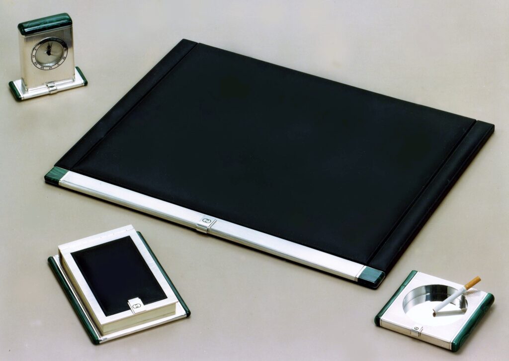 Gucci silver products by Salimbeni. Desk Set with also table clock and ash-trays with onyx or malachite details. 