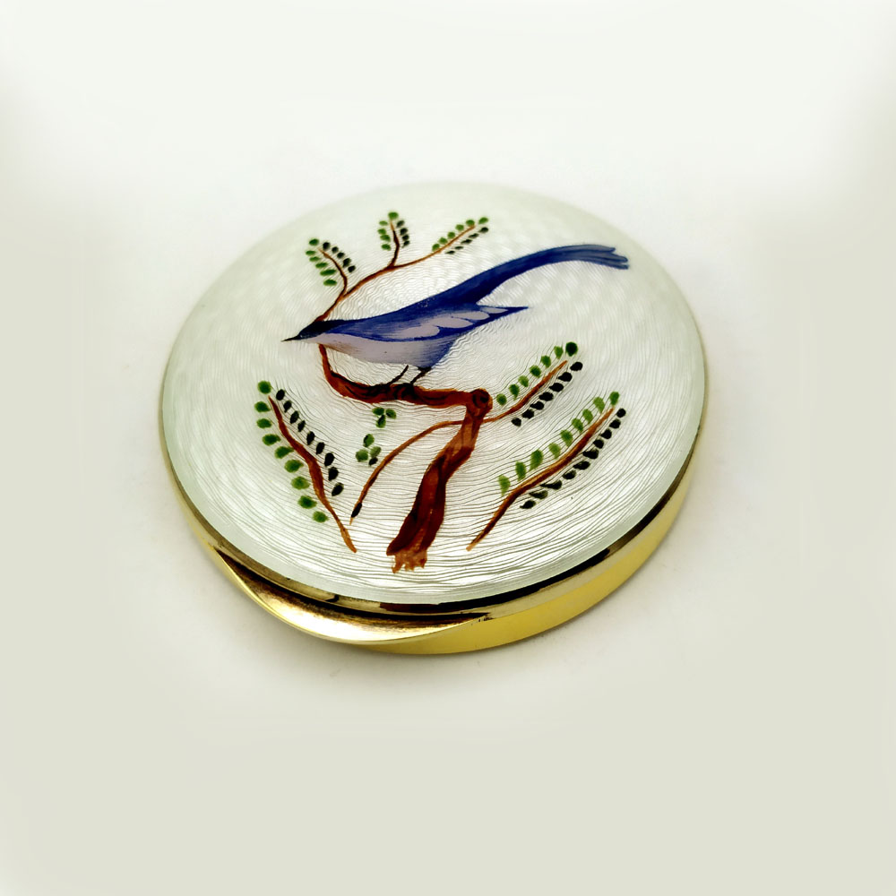 3726-4130 - Round snuff box in 925/1000 sterling silver gold plated with translucent fire enamel on guilloche and hand-painted miniature of stylized blue bird, late 19th-century Viennese Art Nouveau style. Outer diameter cm. 8.5 height cm. 2. Weight 147 g. Designed By Franco Salimbeni in 1973 on the inspiration of earlier objects also manufactured at the Salimbeni firm's headquarters with handwork by skilled craftsmen artists with a thick plate and large reinforcements suitable for sustaining numerous enameling firings at great heat at about 800° C.