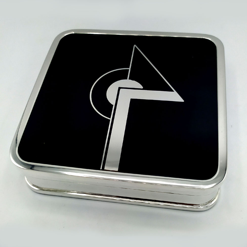 4675-5363 - Square table box for cigarettes with rounded corners in 925/1000 sterling silver with black fired enamel. Measure cm. 12.7 x 12.7 x 3.2. Weight gr. 640. Created in the Art Deco style for Cartier USA in the 1980s, inspired by designs by Louis Cartier from the early 1900s. Manufactured in Florence in the Salimbeni company headquarters with completely manual execution by artisan artists with thick slab and large reinforcements suitable for withstanding numerous high-fire enamelled firings at about 800°