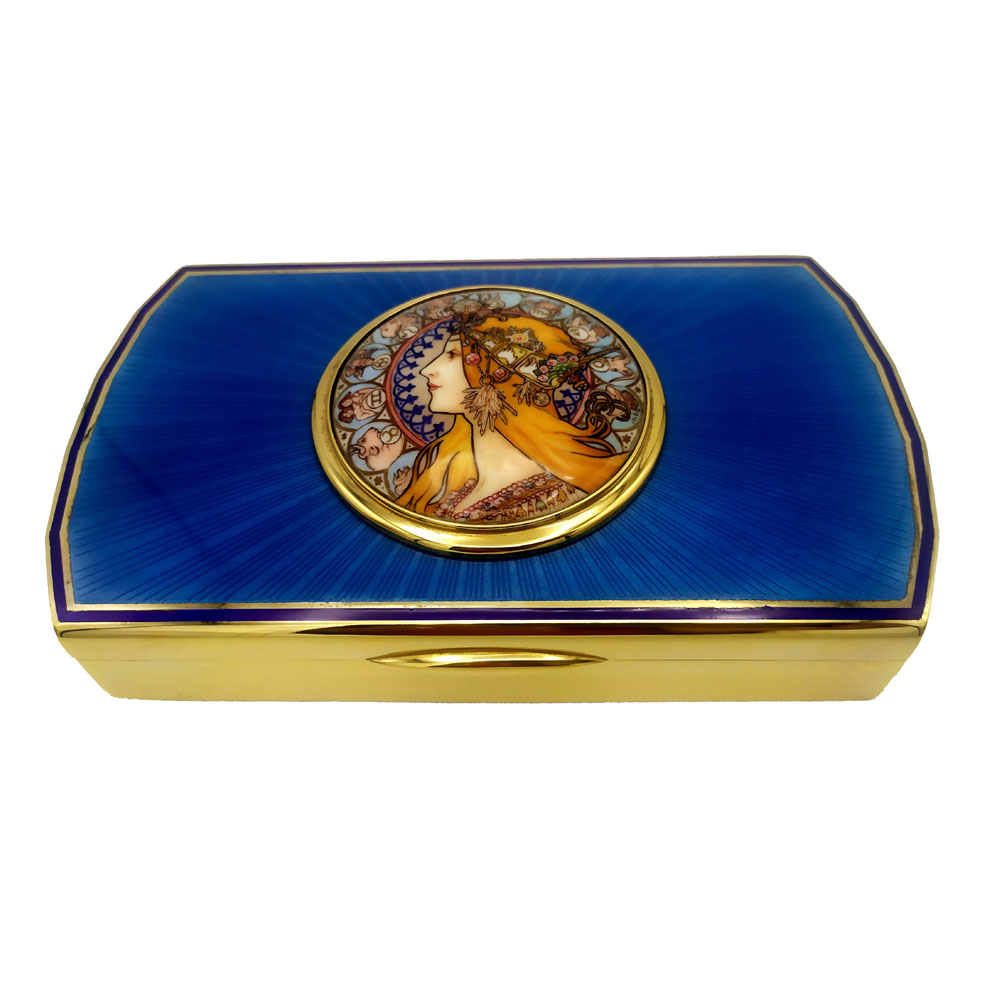 6086-7045 - Large shaped rectangular box in 925/1000 sterling silver gold plated with translucent fire enamels on sunburst guillochè and fine round enamelled miniature 7.5 cm diameter hand-painted by painter Beatrice Mellana reproducing a zodiac poster by Aphons Mucha. Early 20th century Art Nouveau style. With "lost" hinge, i.e., semi-invisible. Outside measurement 12.2 x 20.2 x 3.2 cm. Weight gr. 1110- Designed by Giorgio Salimbeni in 1971 and produced in a single piece at the Salimbeni firm's headquarters by hand by skilled artisans with a thick plate and large reinforcements suitable for sustaining numerous firings of enamelling at great heat at about 800° C.